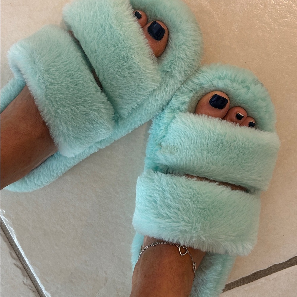 Green fuzzy used slippers for feet toes warm worn shoes well loved foot slides